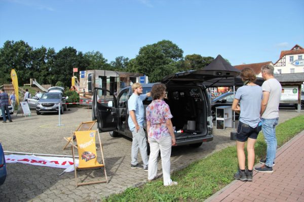 Autohändler beraten Kunden zum Thema Elektroautos.